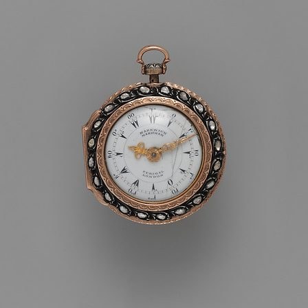 A gold pair-cased pocket watch with a white enamel dial.